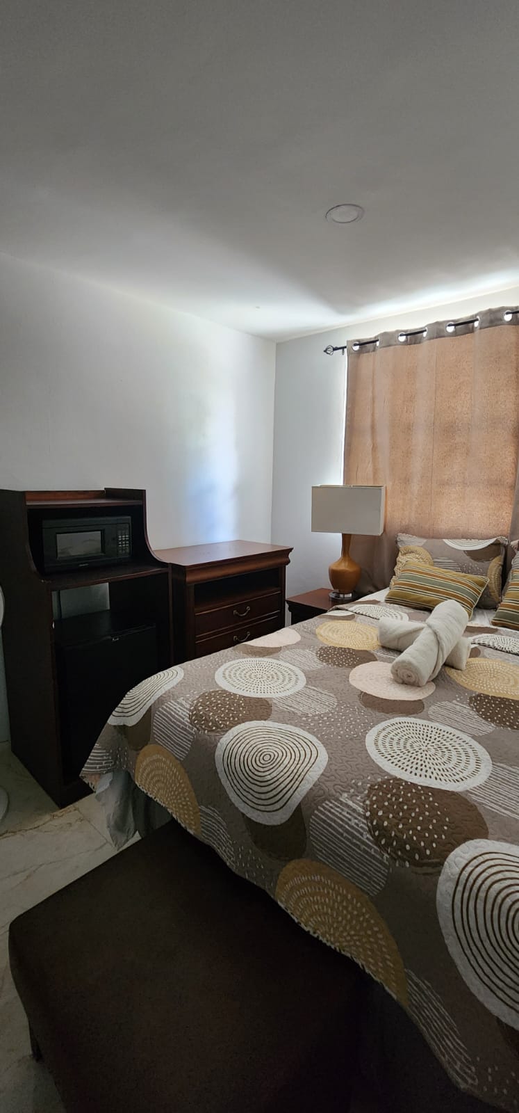 Queen bedroom with microwave and mini-fridge